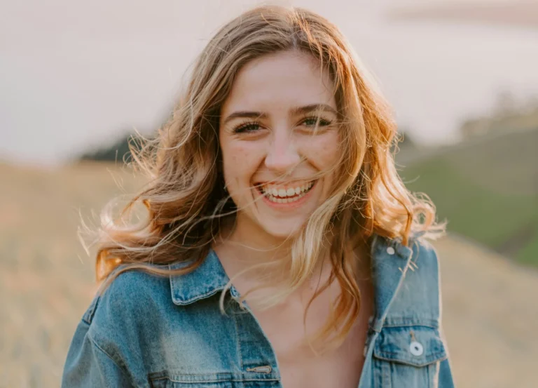 A young woman smiling.